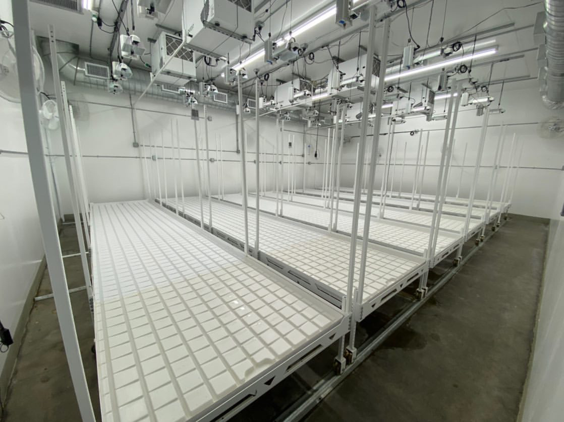 Photo of five 4' X 20' Deluxe Hydro Racks with 4-vgroove and 2-fixed caster wheels the side of each rack.